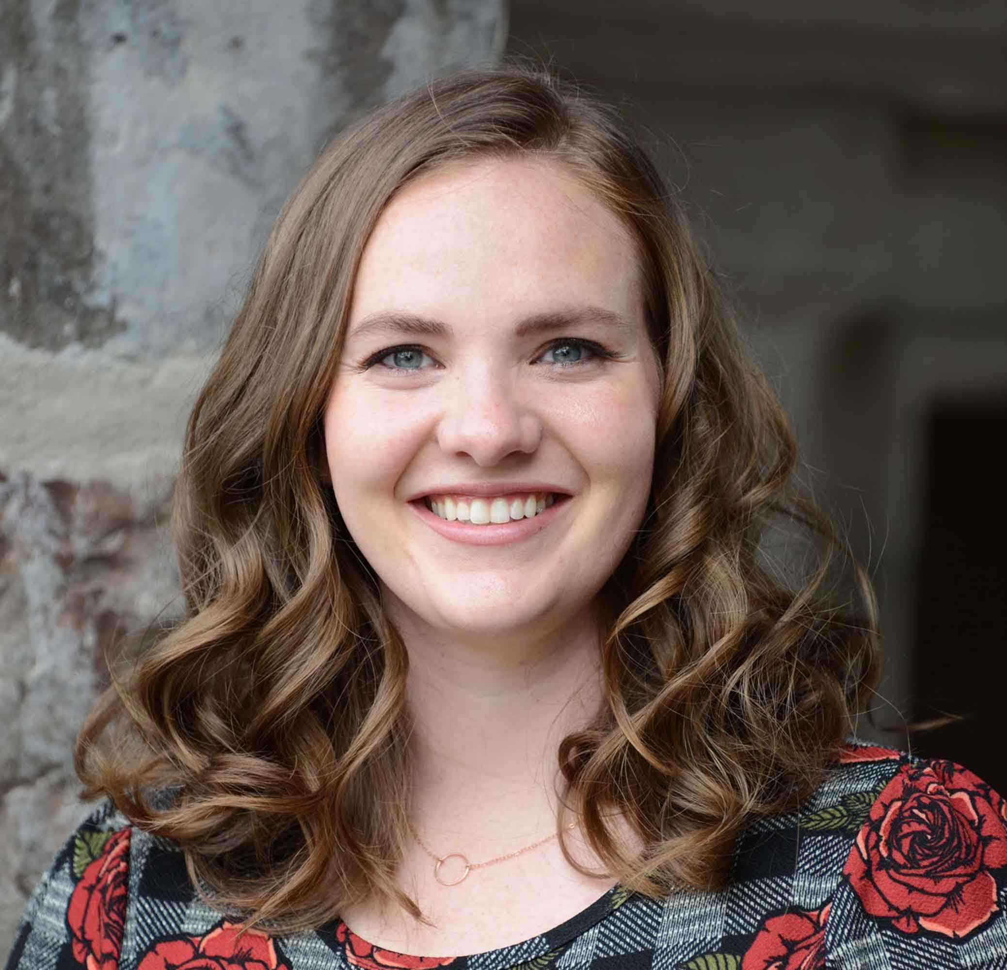 woman smiling with stone background